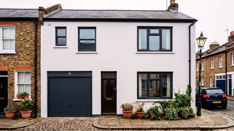 After exterior house spraying London – grey-white render and anthracite grey windows