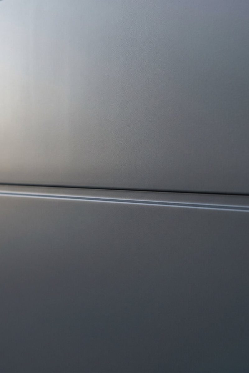 Garage door spray painting London – close-up of anthracite grey satin finish on sectional door