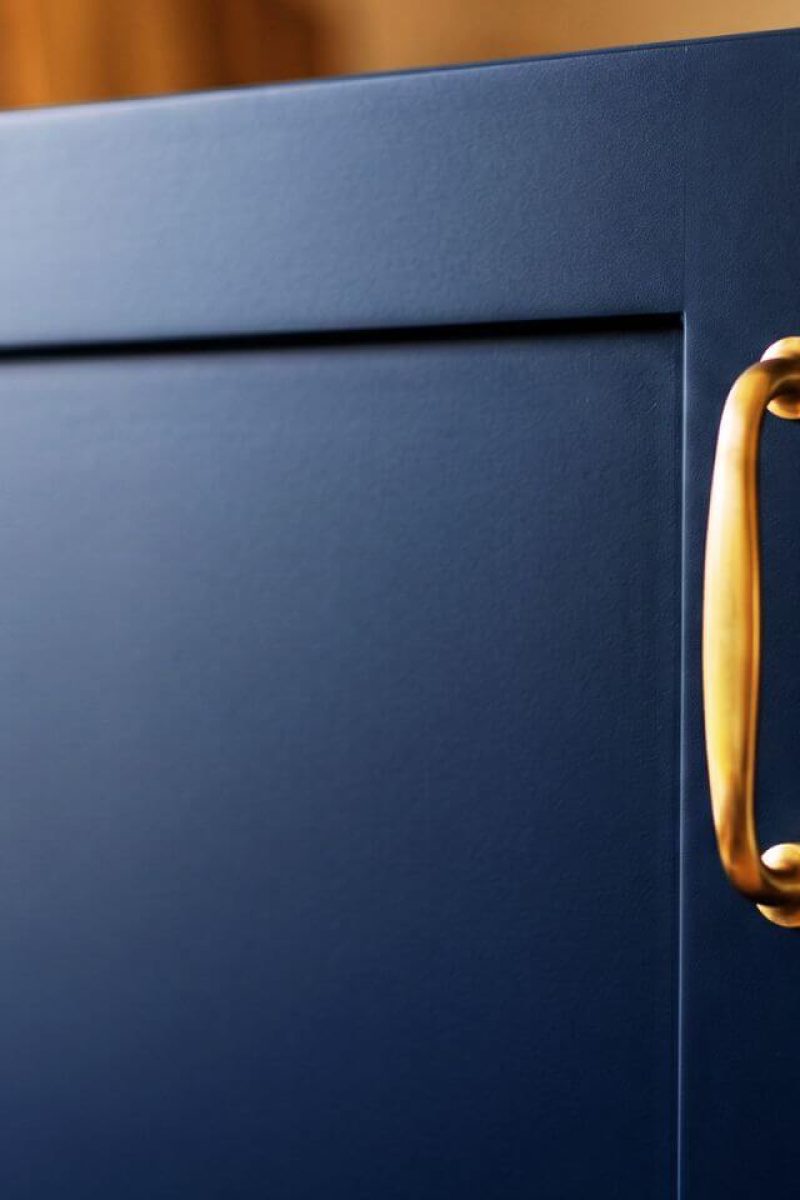Kitchen cabinet respray London – close-up of navy blue matt finish with brass handle