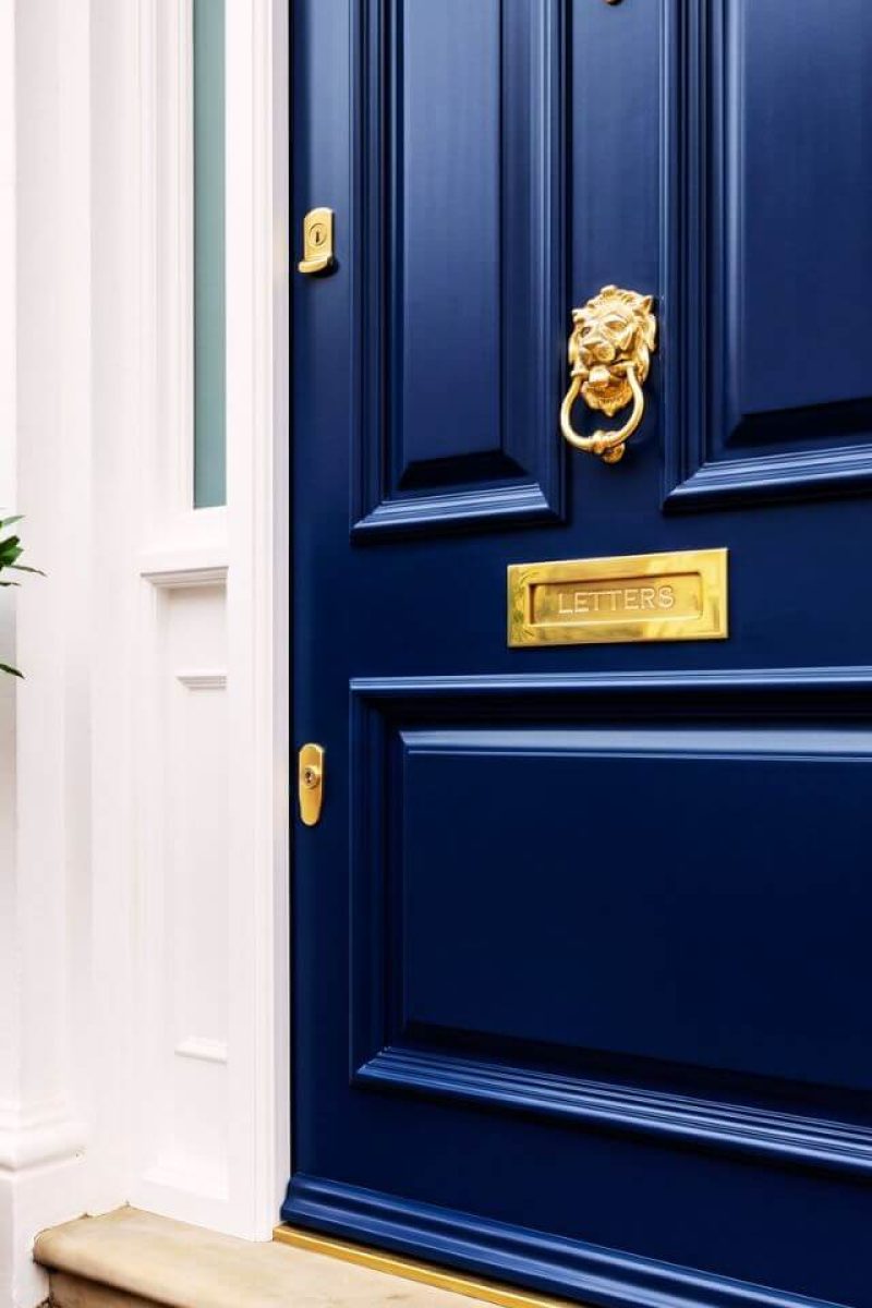 UPVC door spray painting London – navy blue front door with brass hardware close-up