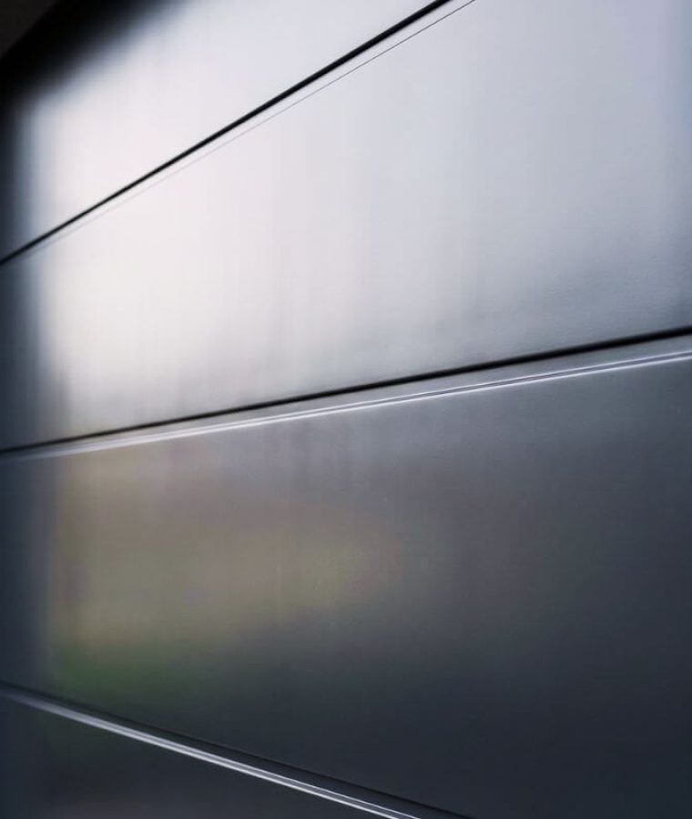 Garage door spray painting London – close-up of anthracite grey satin finish on sectional door