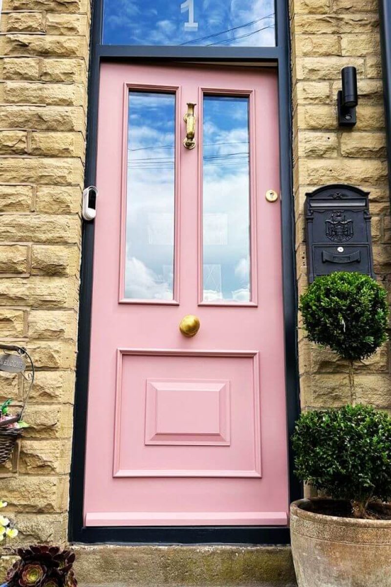 UPVC door spray painting London – light green and light pink doors with brass hardware close-up