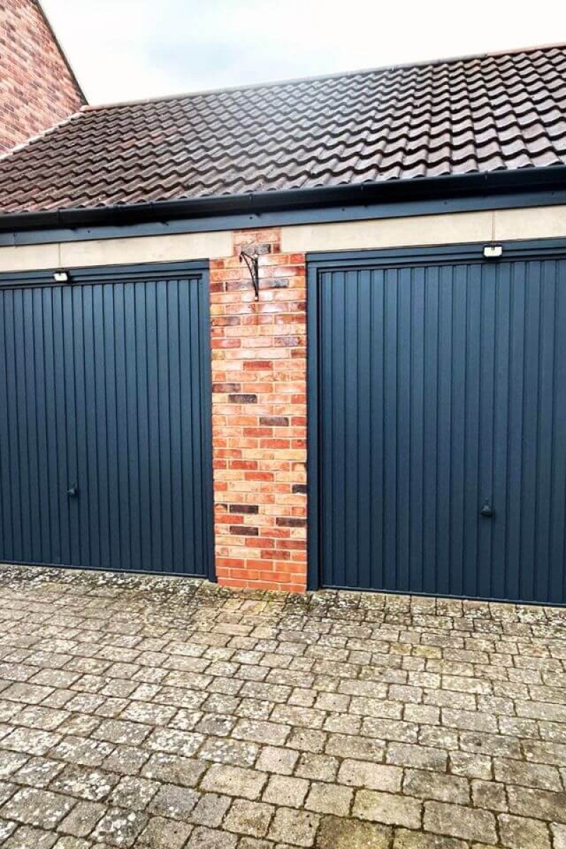 Garage door spray painting London – close-up of anthracite grey satin finish on sectional door