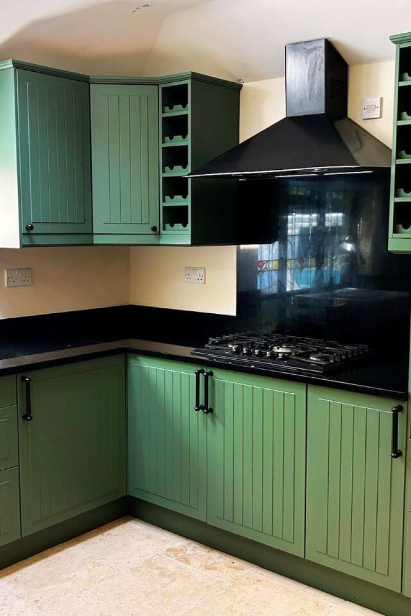Kitchen cabinet respray London – close-up of light green matt finish with brass handle